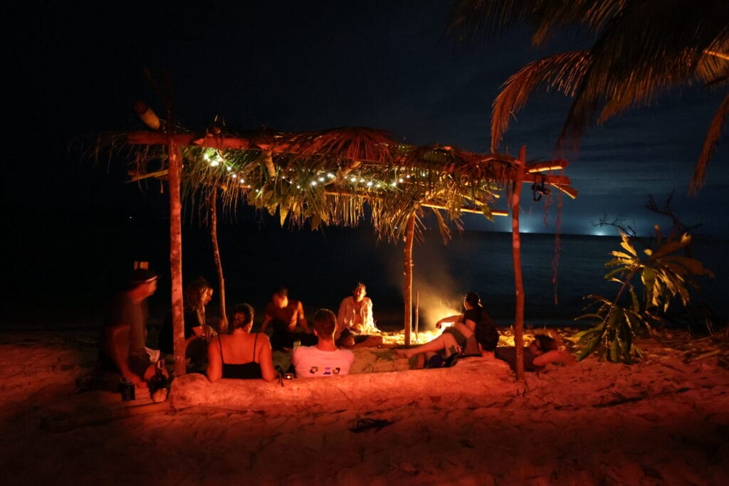 Beach shelter, fire and people talking