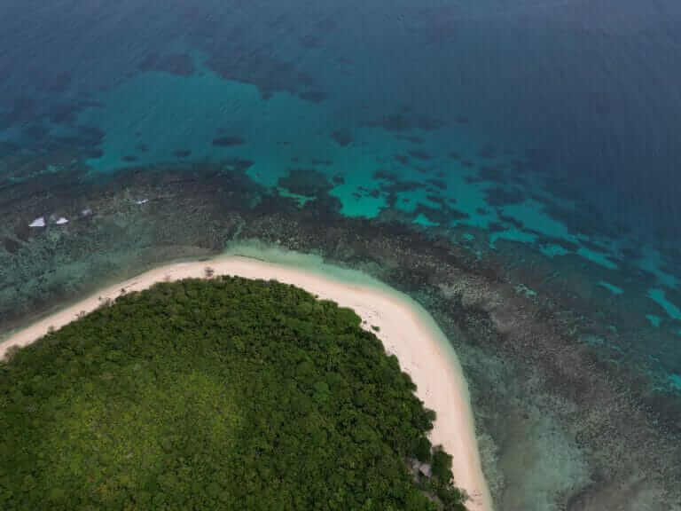 Adventures 5 An aerial view of an island in the ocean.