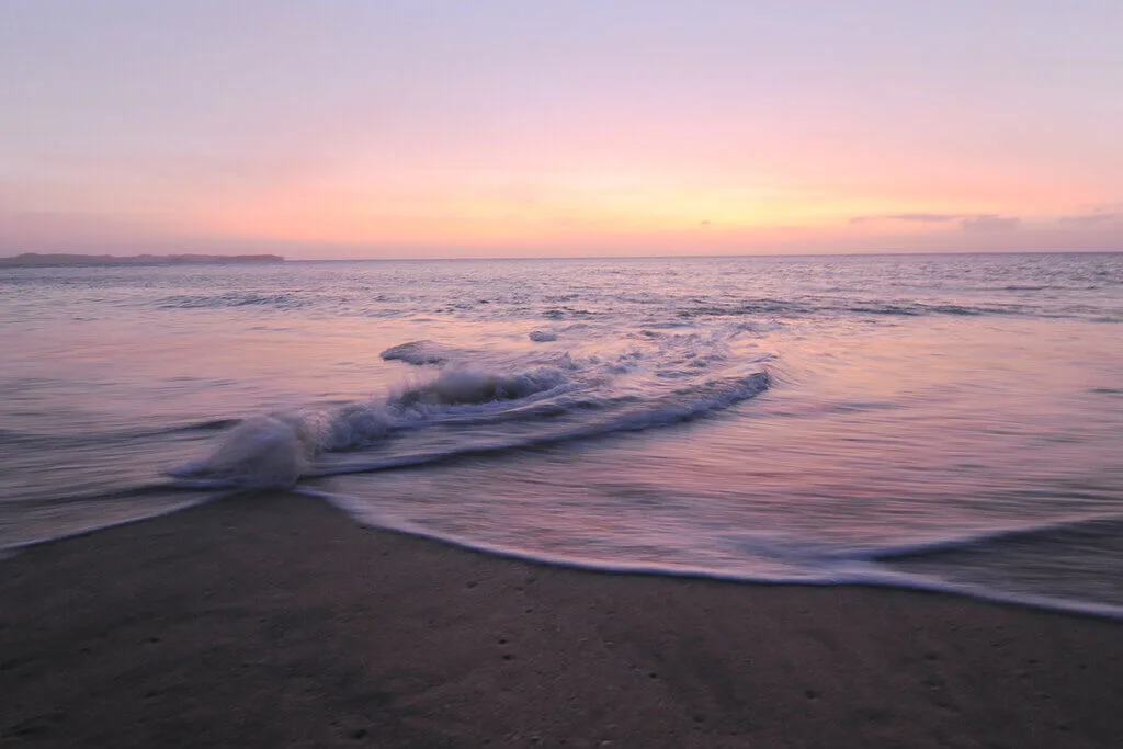 Sunset over a calm beach in Panama; perfect for a private desert island survival adventure.