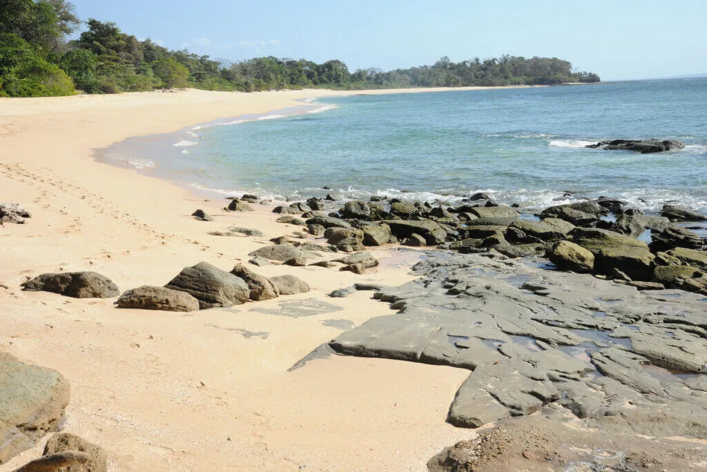 Sandy beach with rocks in Panama, part of a private desert island adventure.