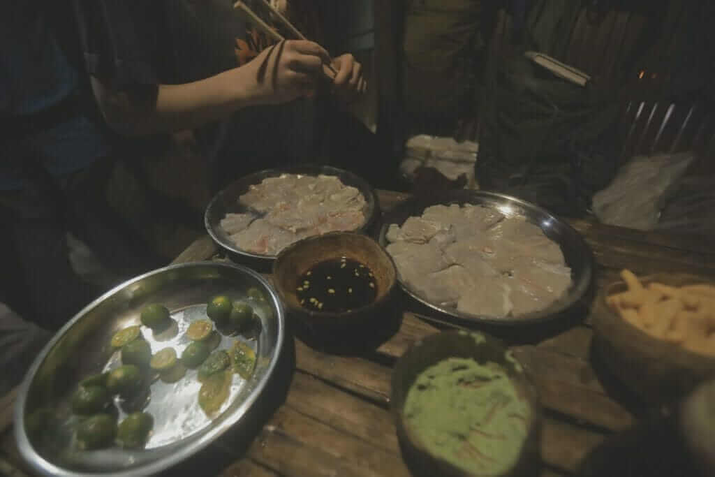 A group of people are preparing food on a table.