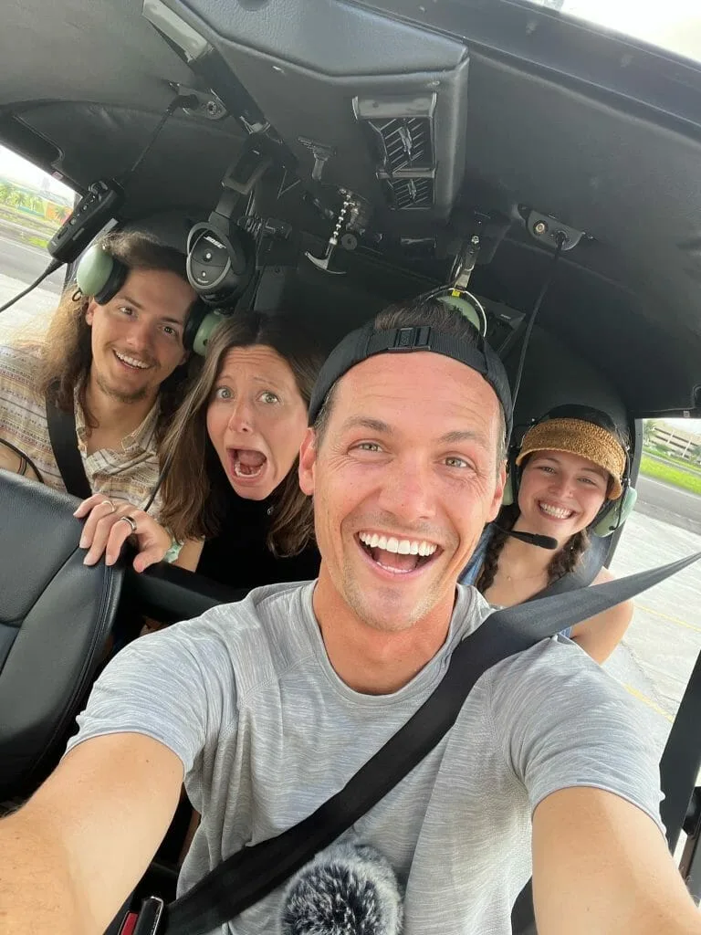 Kara and Nate in a helicopter. Ready for their survival experience