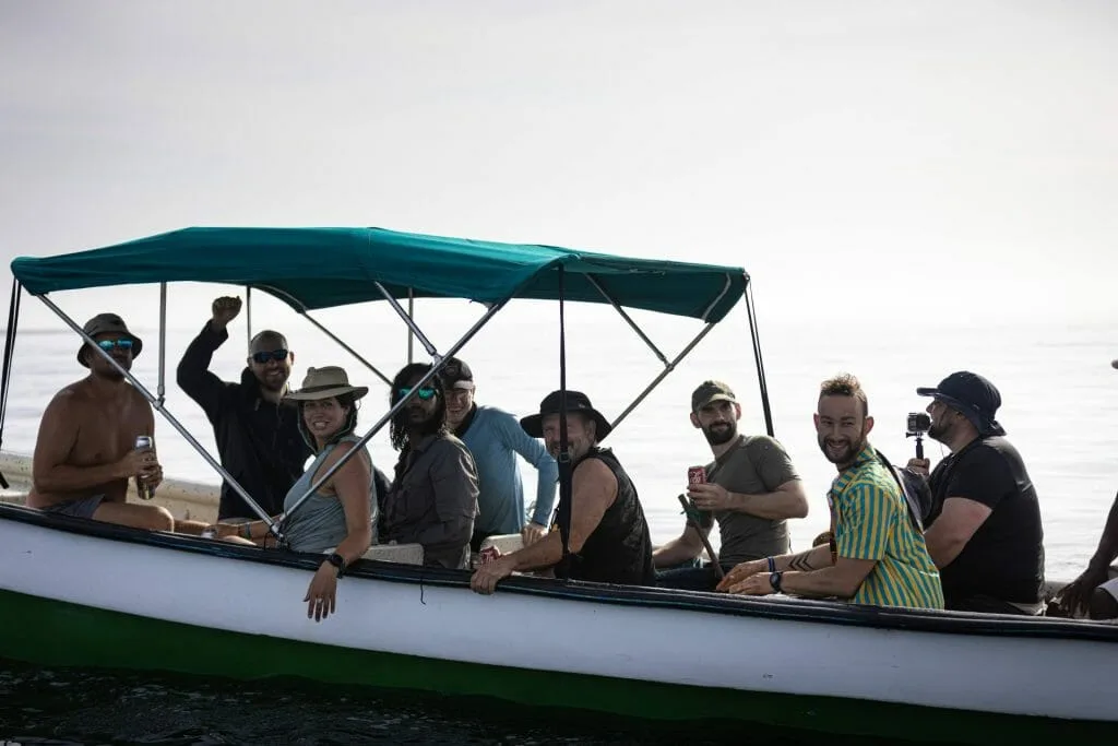 A group of people braving risks on a boat in the ocean.