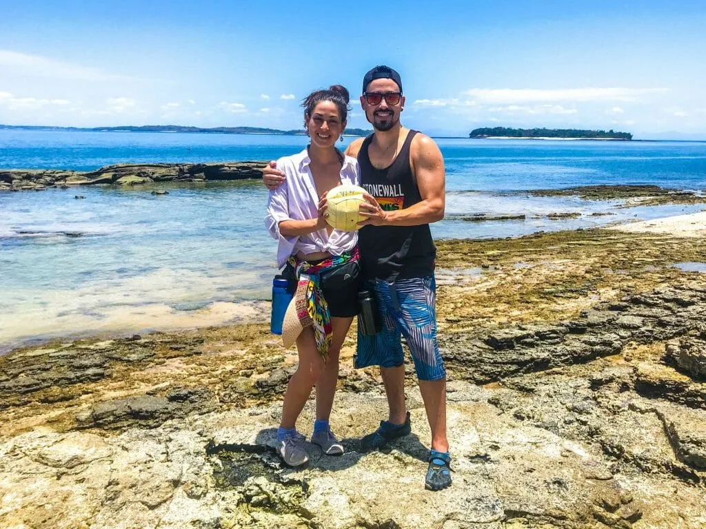 Siblings on beach with a ball in their hand