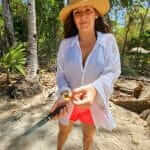 Woman with knife in her hand on beach