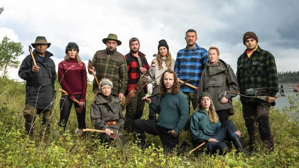 Alone UK contestants with survival gear outdoors.