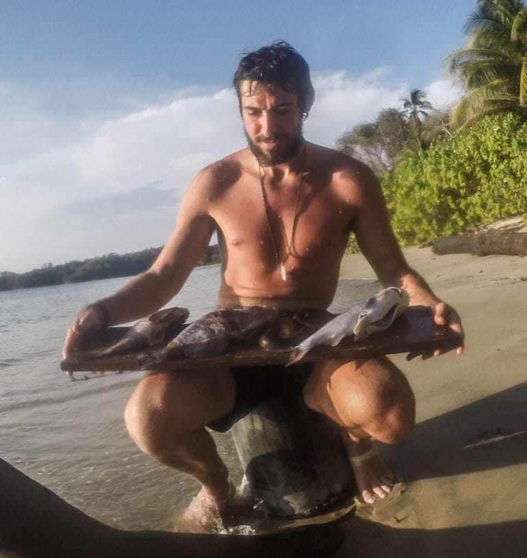 Stranded on an island? Here's an Insight on How You May React - The Ultimate Survival and Personality Test 6 Man with fish on beach