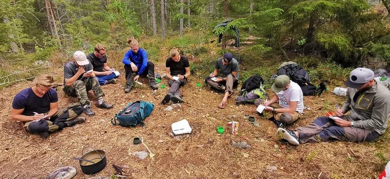 group taking notes on survival skills