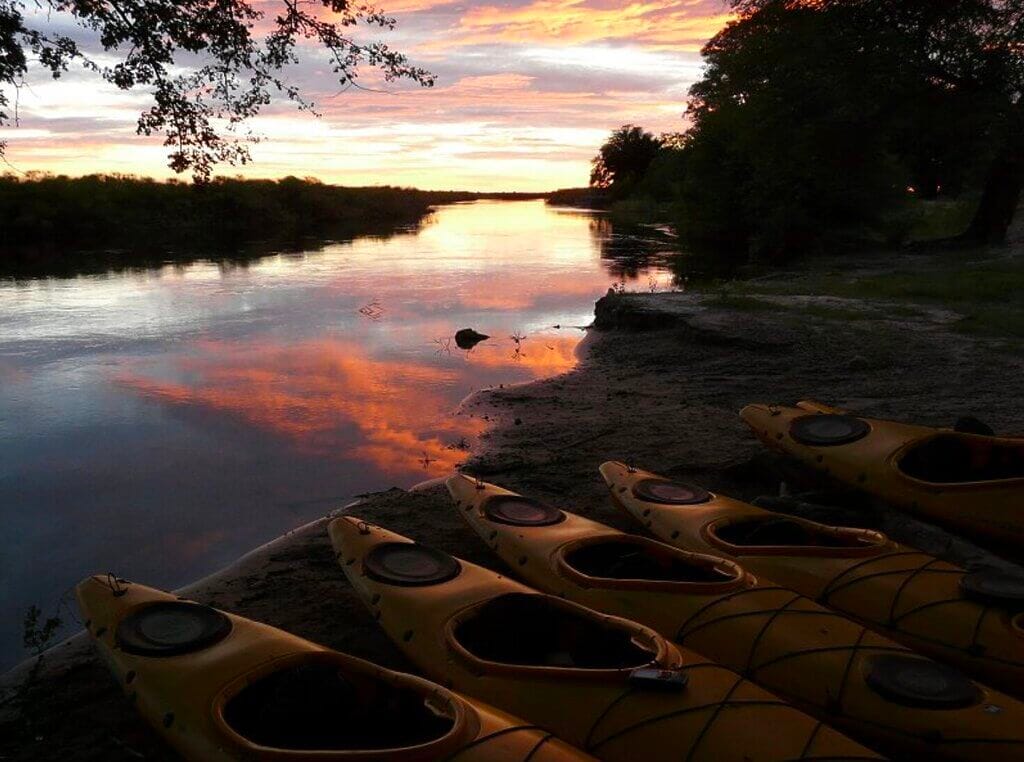 kayaks, sunset by river