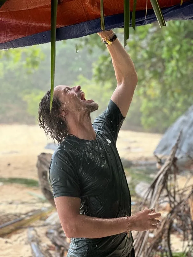 Man drinking rain water