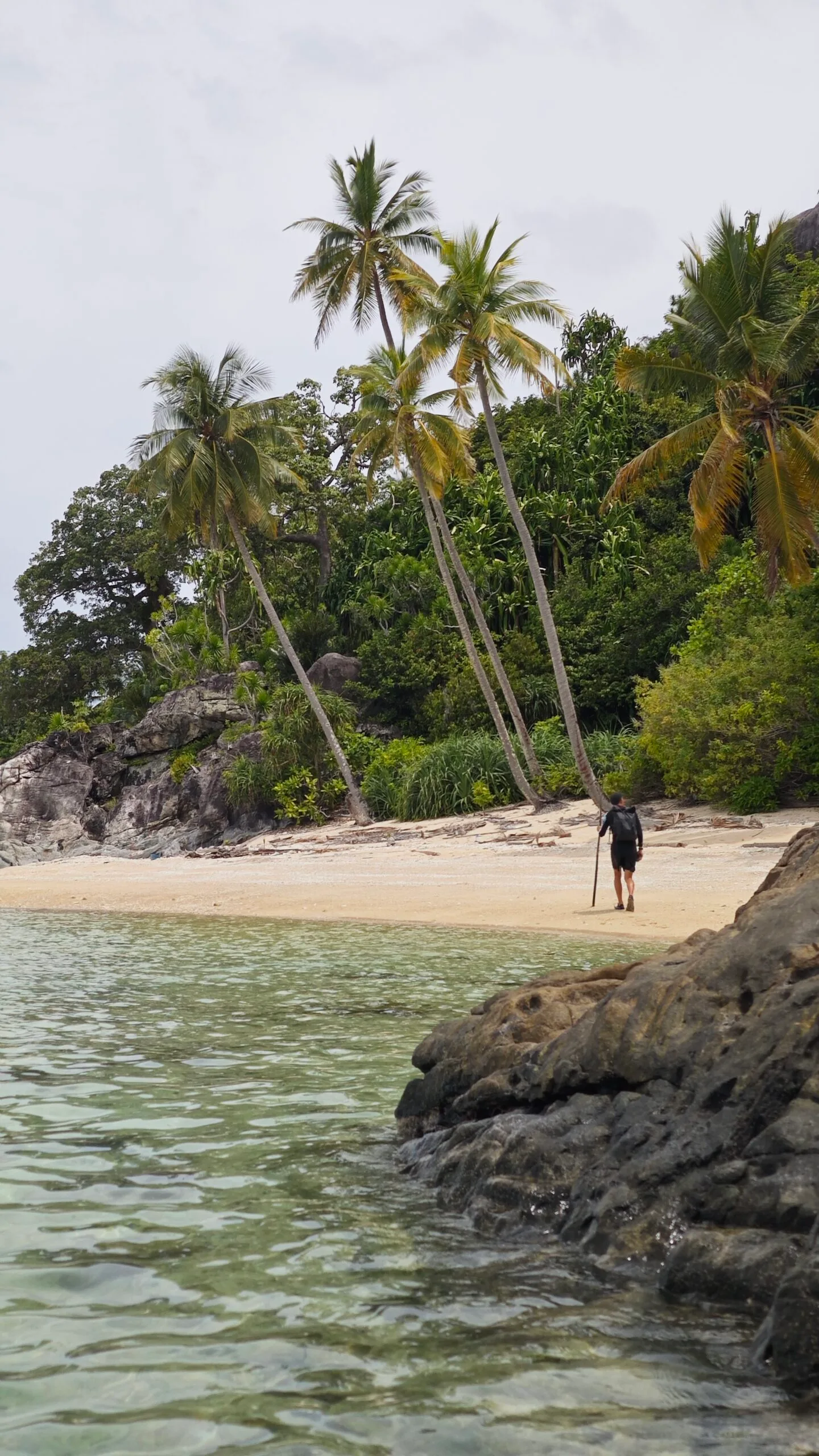 man walking on beach Indonesia