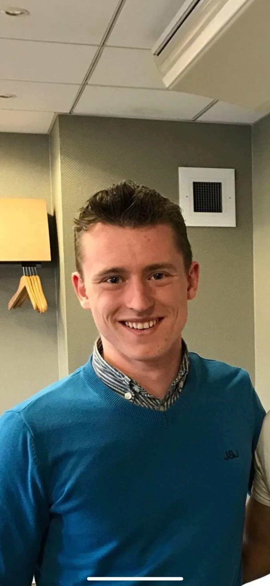 Smiling man in blue sweater. Panama survival adventure participant.