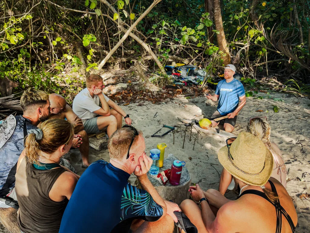 Group learning survivor strategies outdoors on a sandy beach.