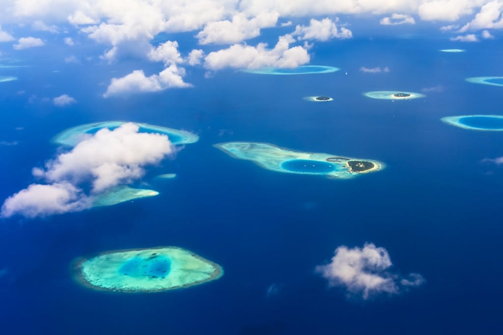 The Maldives Beyond Honeymoons. Adventure Meets Paradise 3 A breathtaking aerial view of tropical islands and azure blue waters, showcasing stunning natural beauty.