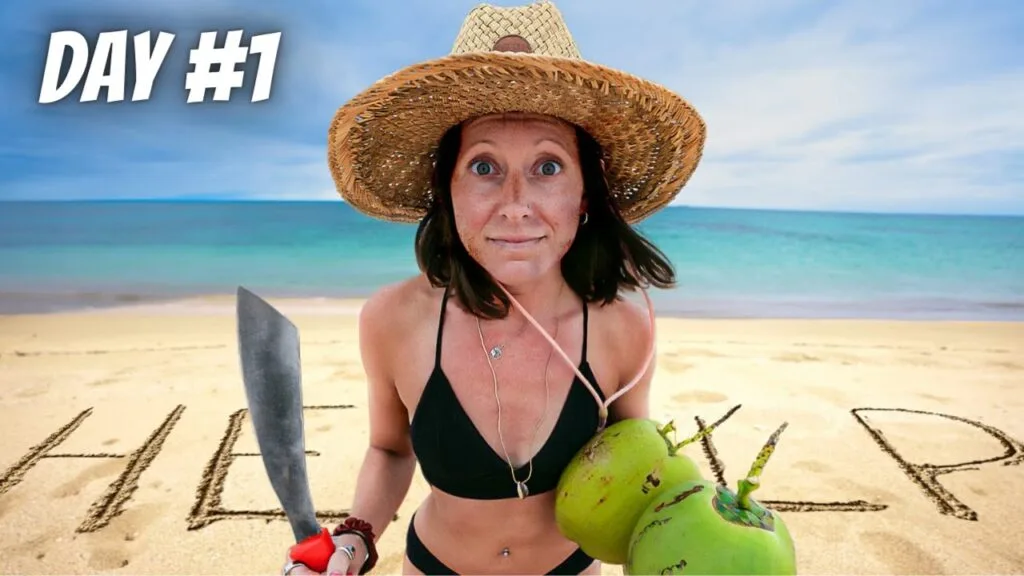 Woman with coconuts and machete on beach with "HELP" written in sand.