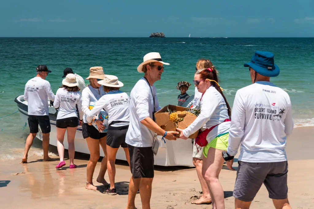 People unloading supplies for a Virgin Adventures desert island survival trip in Panama, 2025.