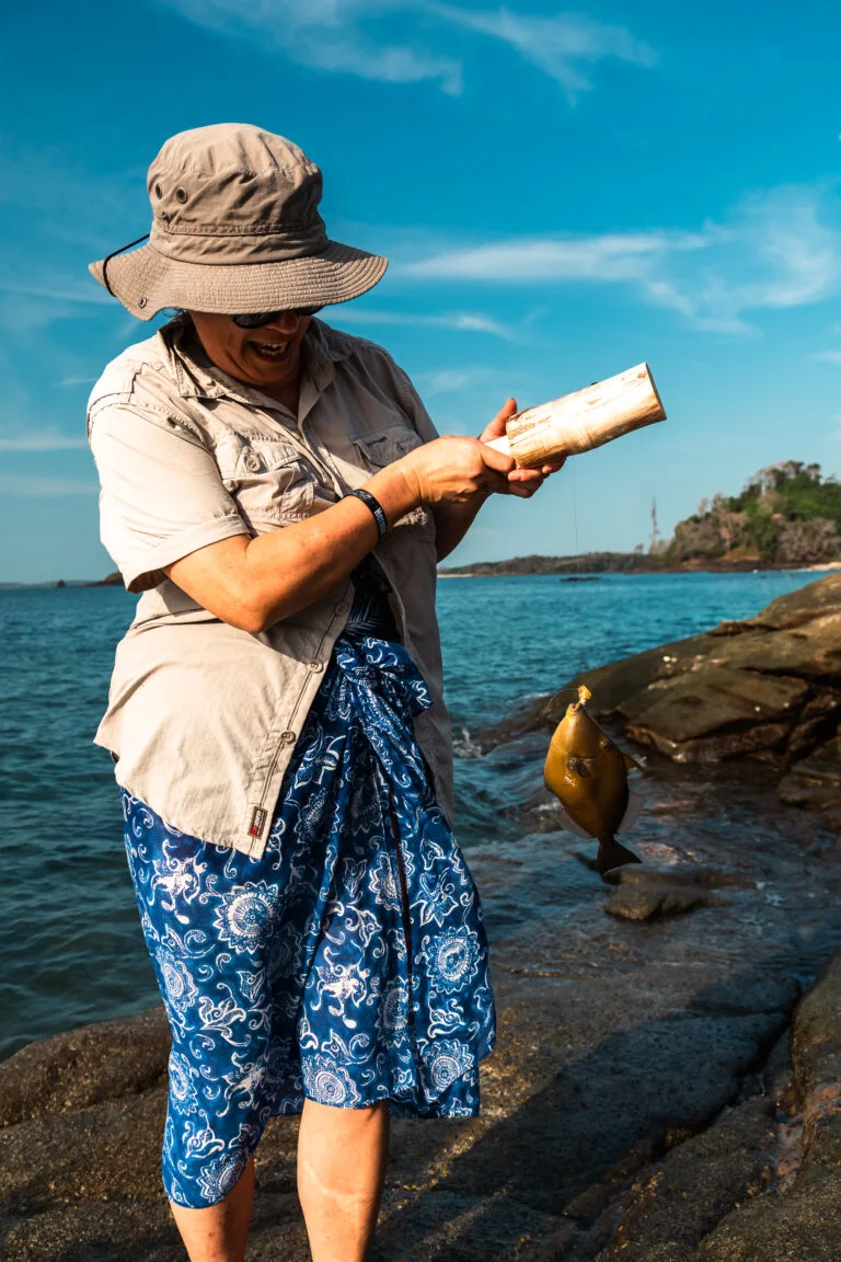Woman fishing with a hand reel, caught a fish. Private Adventures.