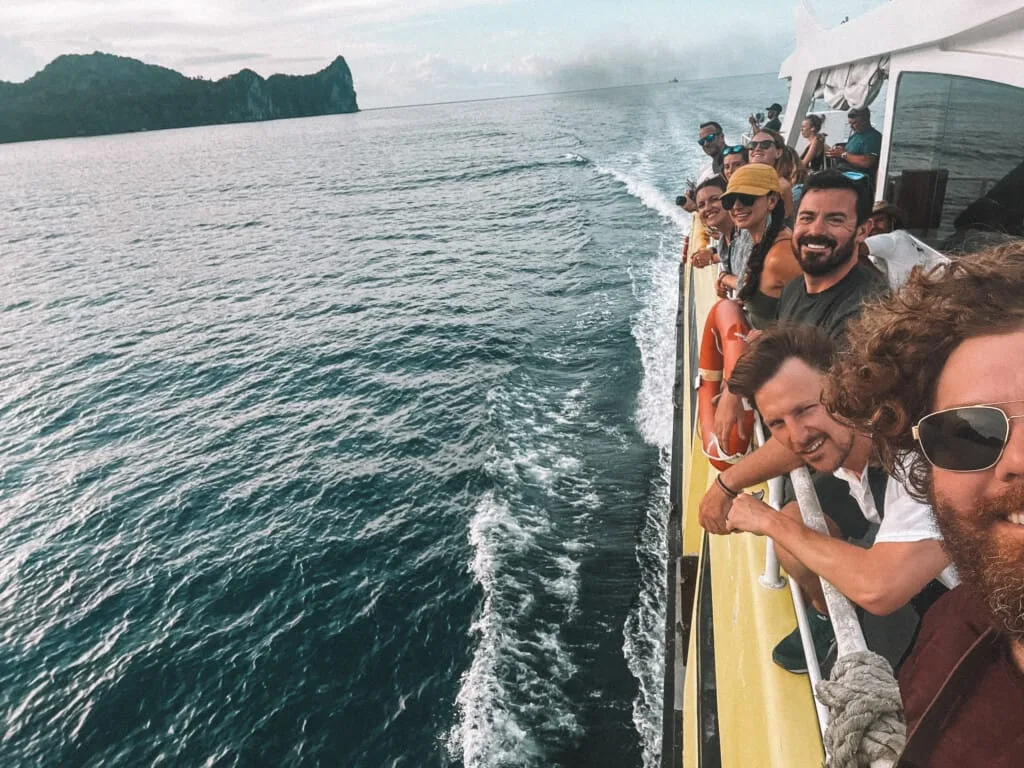 Boat trip with happy tourists enjoying the ocean view, keeping our adventures safe.