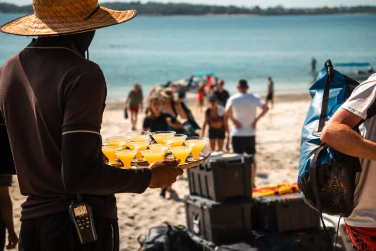 Refreshing tropical drinks served on a sunny beach during a desert island survival event.