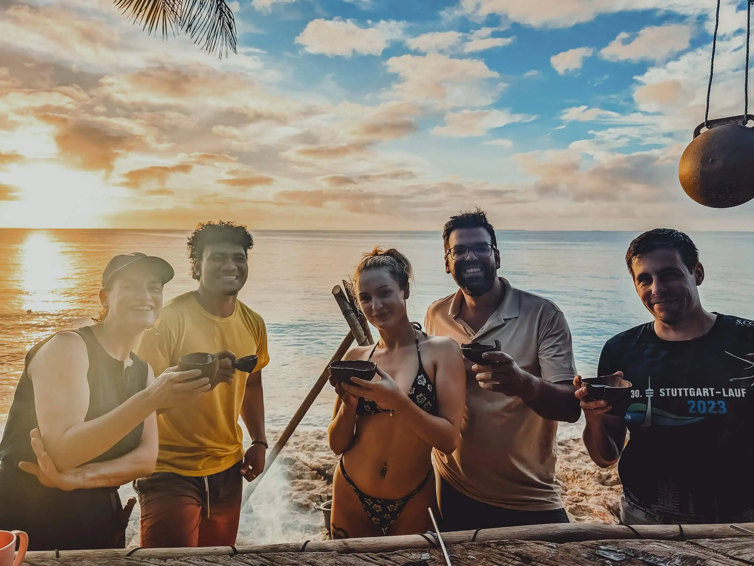 Desert Island Survival Adventure in Tonga 15 Escape to a tropical paradise with friends enjoying drinks on the beach at sunset, highlighting survival skills and island adventure experiences in a desert island setting.