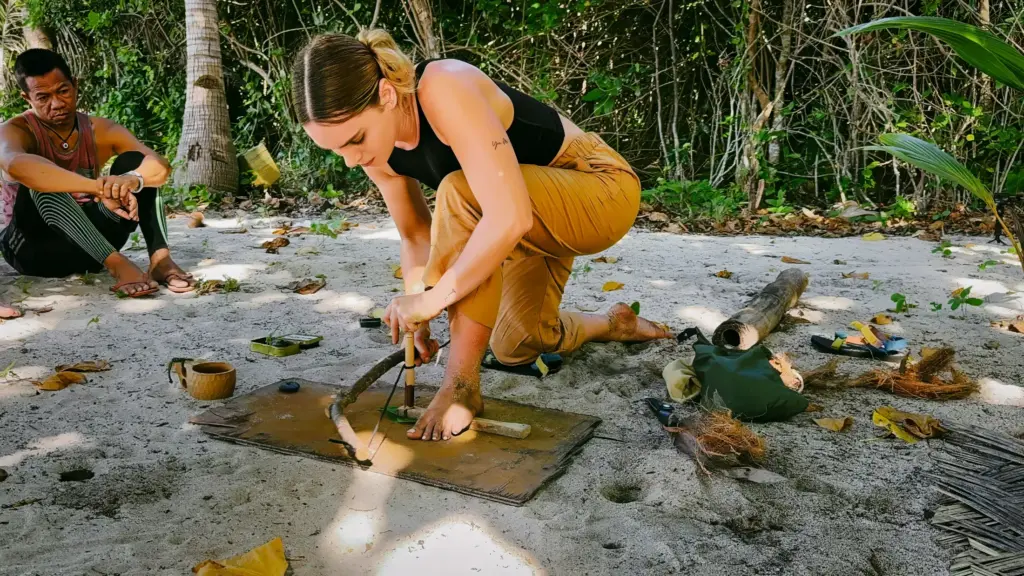 Survival instructor demonstrating fire starting technique in the Philippines.