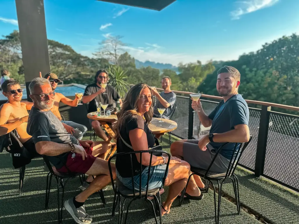 Group enjoying cocktails with a scenic view. Relaxing outdoor gathering.
