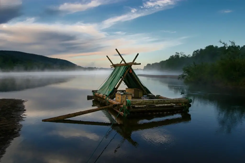 Raft with tent on misty lake in Sweden. Calm, peaceful scene.