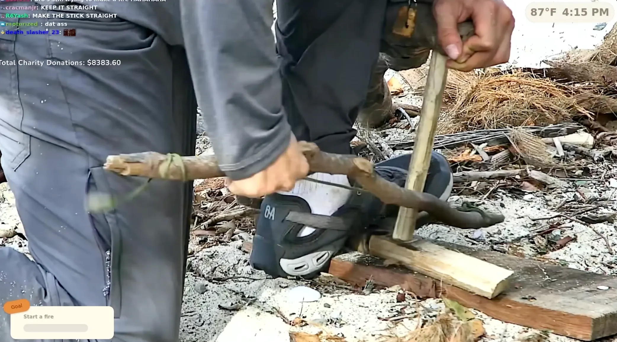 Person using a bow drill to start a fire, survival skills demonstration.