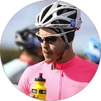 Cyclist in pink jersey and helmet holding yellow water bottle. Outdoor cycling, sporty.