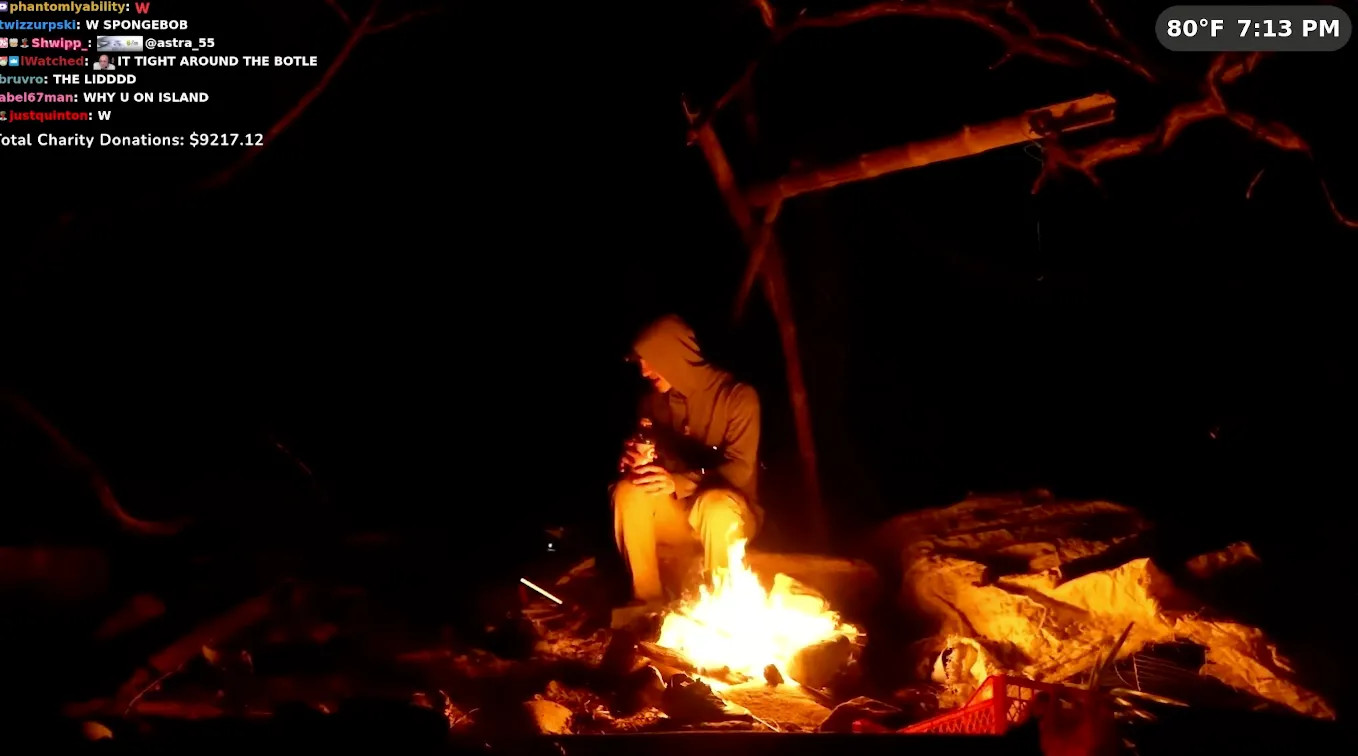 Person by campfire at night, with chat overlay and temperature display.